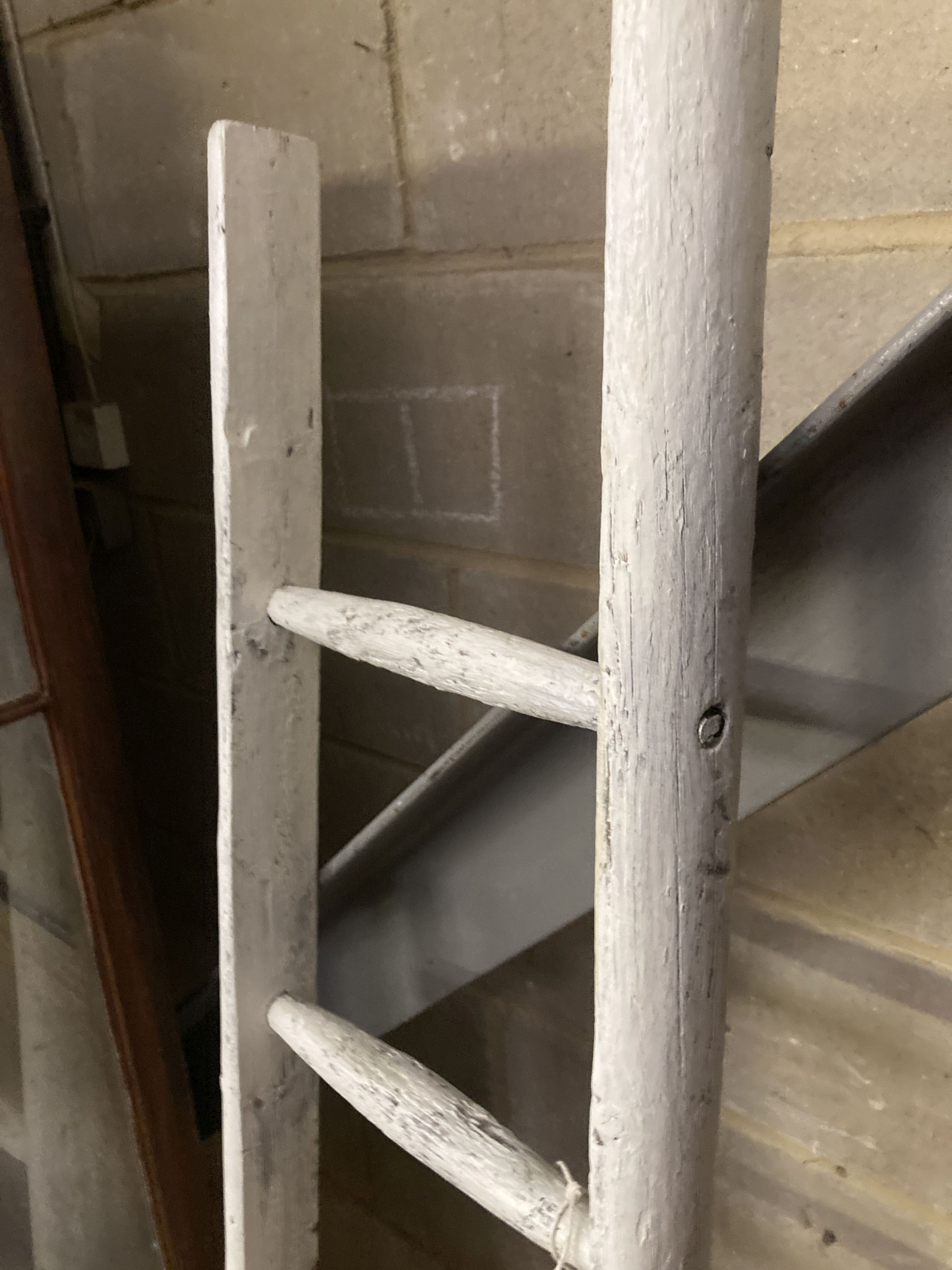 A vintage white painted wood seven tread ladder, width 30cm, height 170cm